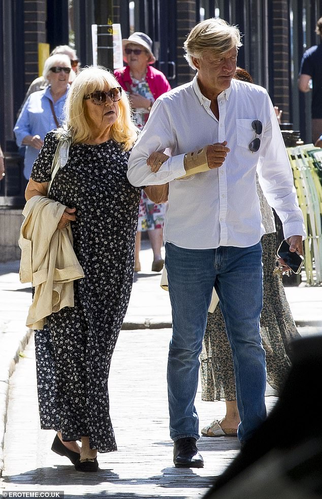 The married couple were enjoying a romantic outing around the swanky Hampstead area as Good Morning Britain presenter Richard, 69, proved ever the gentleman by offering her his arm despite his double fractured wrist