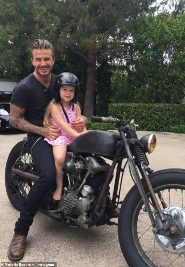 Victoria shared an adorable photo of Harper perched on a motorbike with her father David