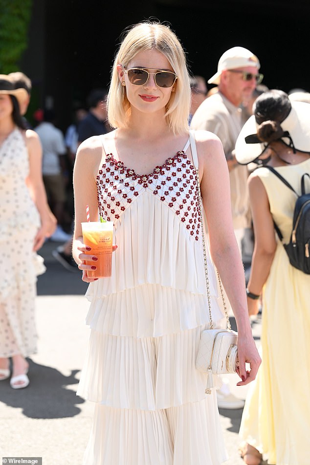 Actress Lucy looked in great spirts as she walked around with a Pimm's