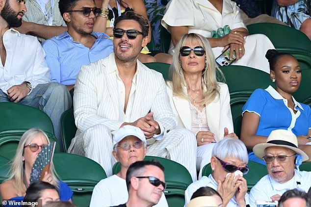Chris Appleton looked stylish in a pin striped white suit