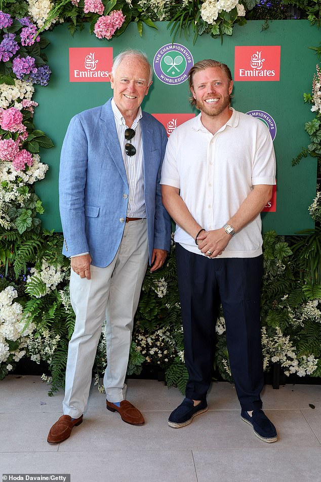 Comedian Rob Beckett paired a Wimbledon white top with navy trousers and espadrilles as he posed alongside Sir Tim Clark