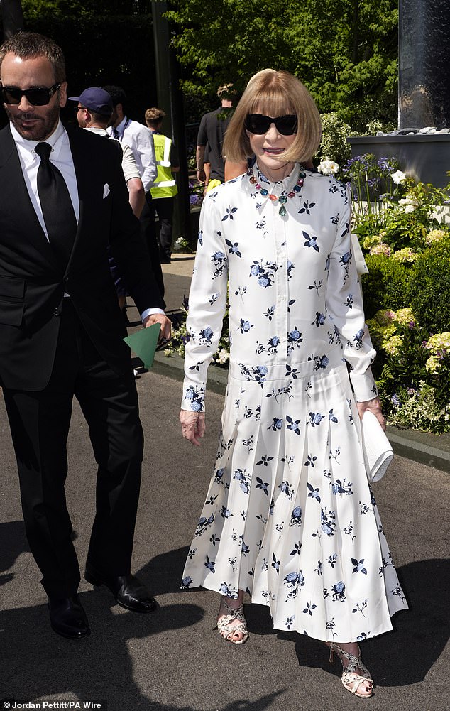 Anna Wintour joined the men as she wowed in an elegant white buttoned up dress adorned with blue flowers (pictured with Tom Ford)