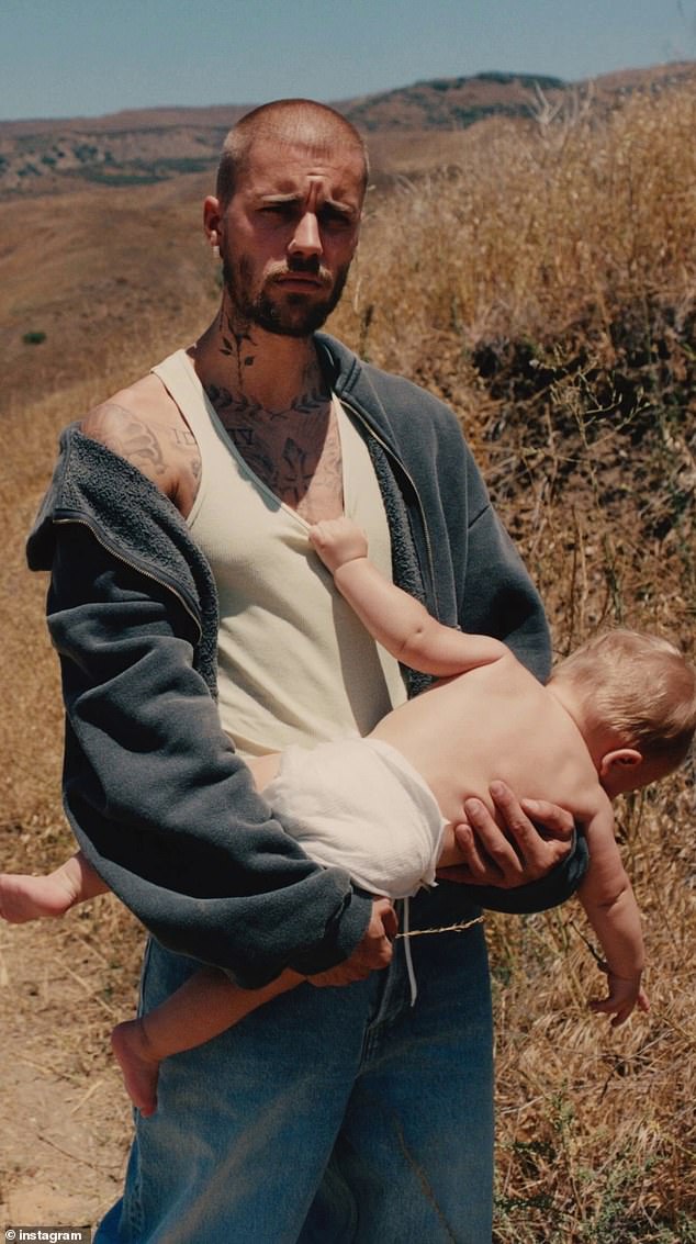 News of the feuding pair's long-awaited settlement comes just hours after Bieber ¿ who sold his musical catalogue for $200million in 2023 amid his financial troubles ¿ announced he will be releasing a new album, titled Swag; seen with son Jack Blues