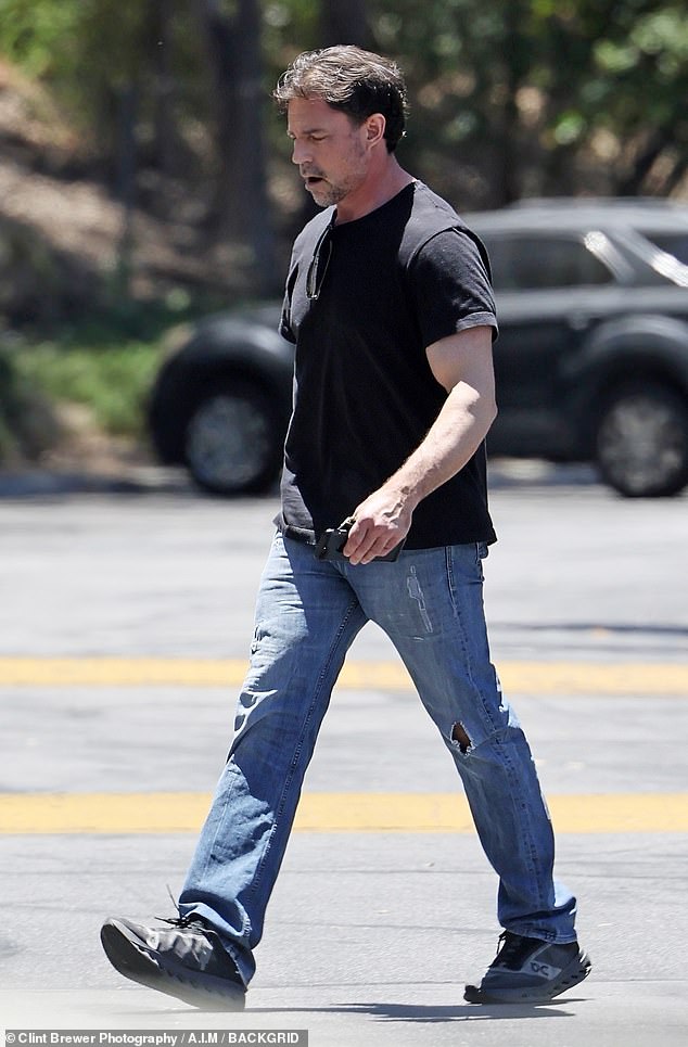 The 52-year-old entrepreneur wore a black T-shirt, distressed jeans, and gray sneakers as he removed his wedding ring in his first public sighting since the split