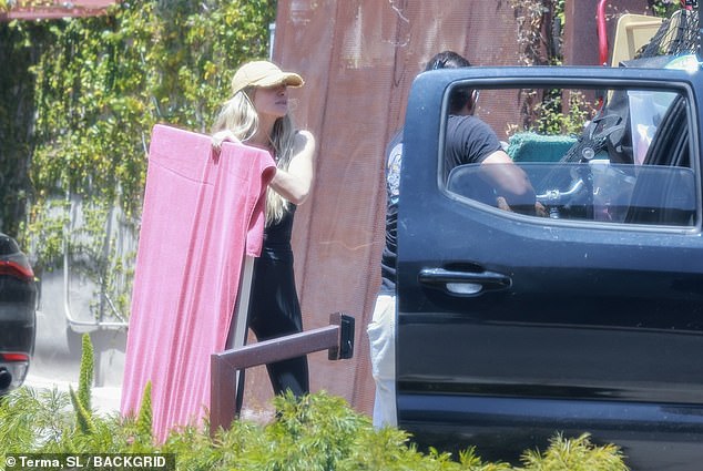 But it wasn't long before Jess got back to work, carrying some large items of her own which she protected with bed sheets