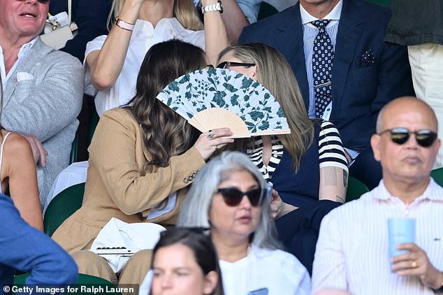 But can you spot the celebrity having a secret kiss in the crowd? Cara Delevingne attempted to keep her romance on the down low as she was spotted sharing a smooch with an mystery woman