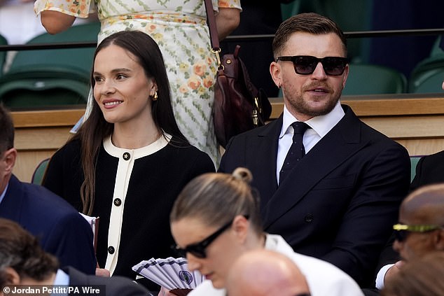 Holly kept it simple in a black cardigan with cream edging