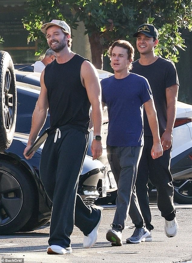 Patrick, 31, displayed his genetically blessed biceps¿no surprise given his father was once Mr. Universe¿wearing a black tank top and matching pants as he led the way