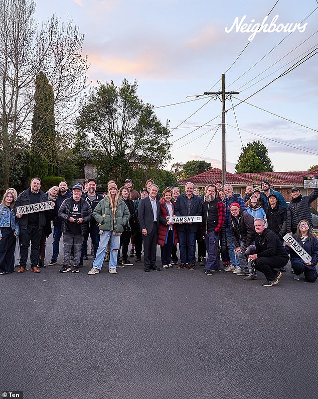 Another image showed the whole Neighbours cast dressed up warm as they posed on Ramsay Street during their final stint on set