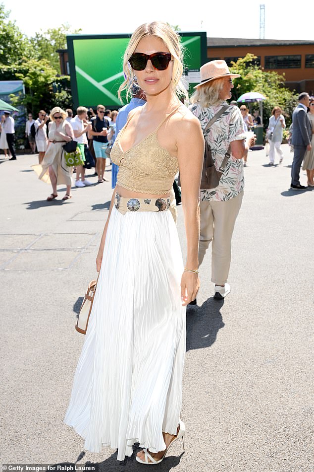 Sienna, 43, turned heads as she put on a busty display in a plunging crocheted crop top, that flashed a glimpse of her toned midriff