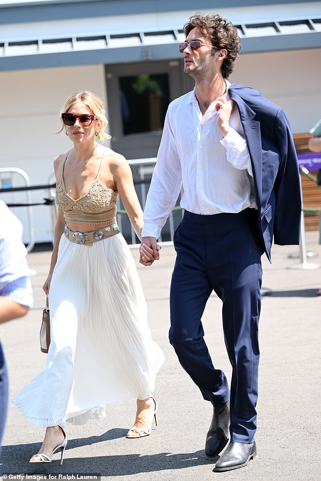 Sienna completed her look with a pleated white maxi skirt and a chunky Western-style belt covered in engraved silver buckles, to cinch her in at her tiny waist