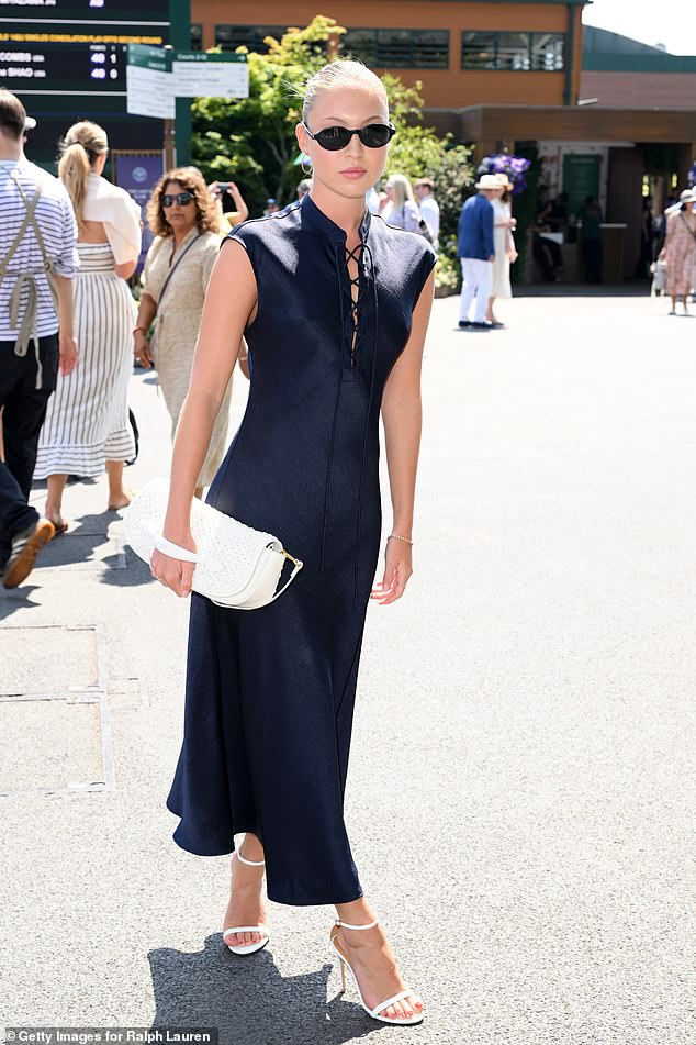 Lila made sure all eyes were on her in the long striking dress which showed off her amazing figure and featured a plunging lace up neckline