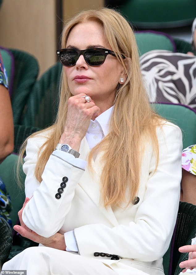 Nicole looked elegant in a fedora hat as she sat beside Anna