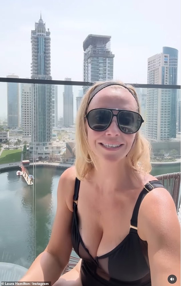 A Place In The Sun presenter Laura Hamilton posed on her balcony looking out on the incredible view of Dubai marina whilst wowing in a racy black swimsuit with sheer panels