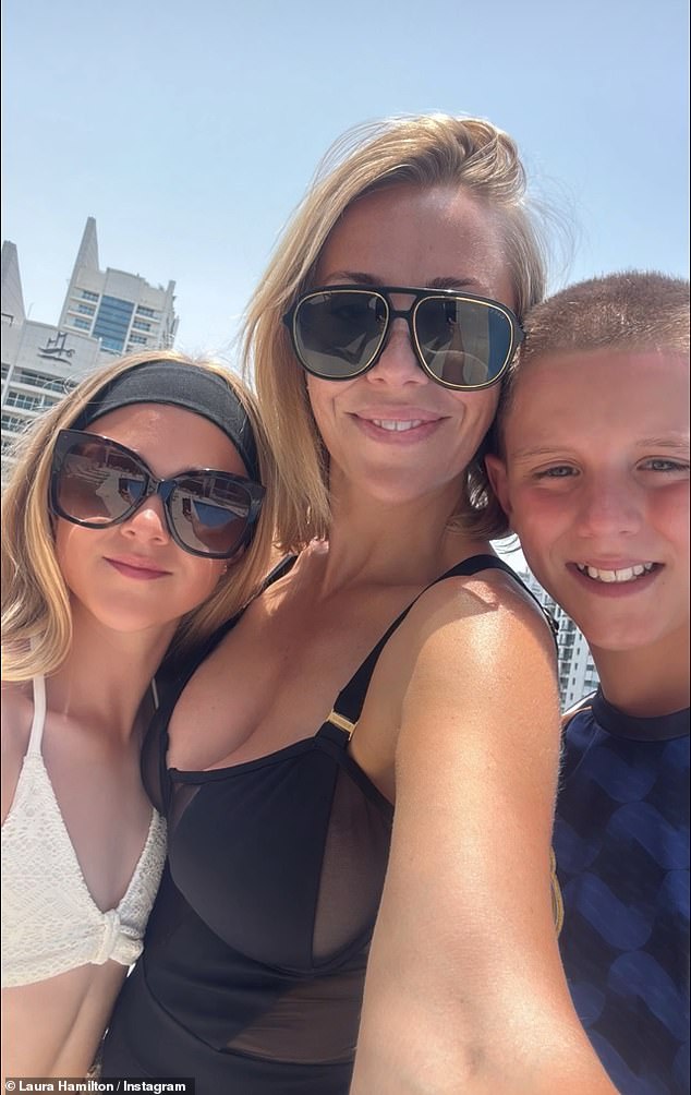 The TV star showed off her tan in the chic one-piece before posing for a photo with her two children, who she has been showing the new holiday home to this week