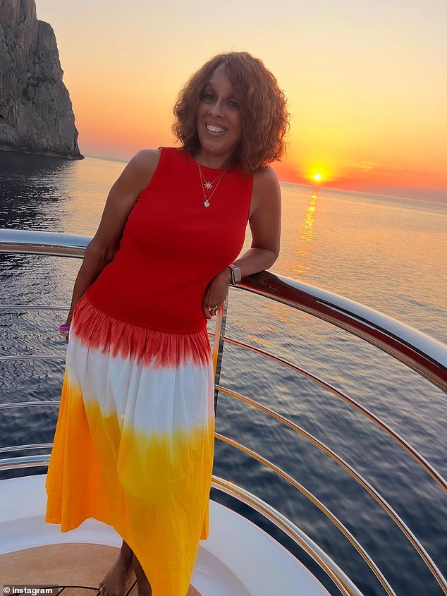 Gayle looked joyous as she posed in front of the stunning landscape