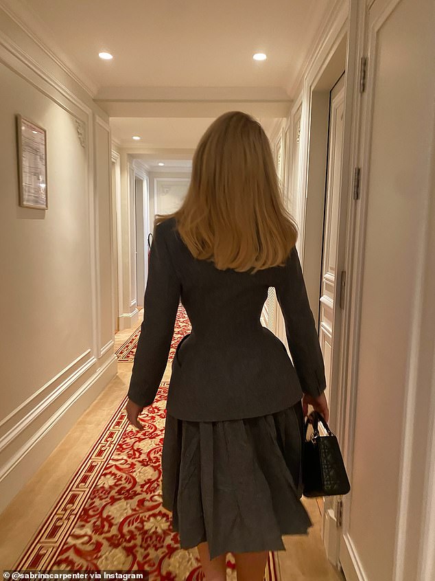 Carpenter was all business in another photo, showing of her hourglass figure in a 1950's inspired gray suit with a matching jacket and flouncy skirt