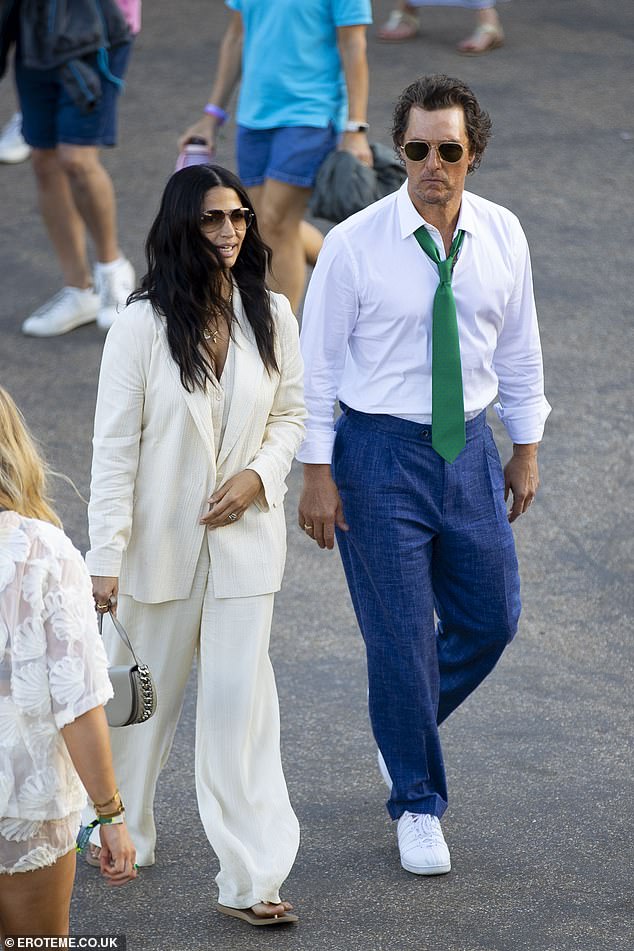 Matthew shielded his eyes with aviator shades as the couple soaked up the sun before the evening fun