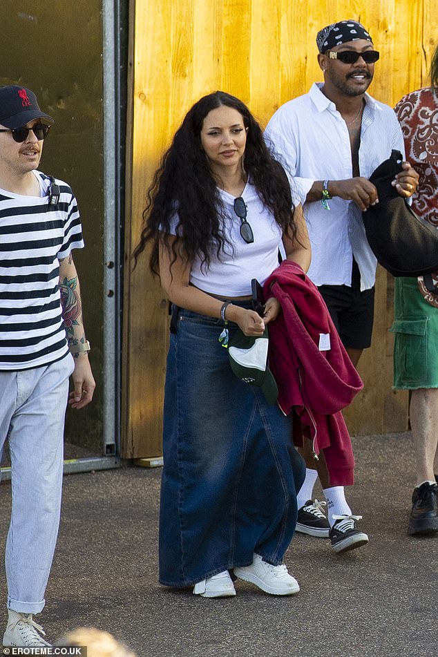 The singer, 32, kept it casual in wide-leg jeans and a white T-shirt, while she carried a red cardigan in her arms