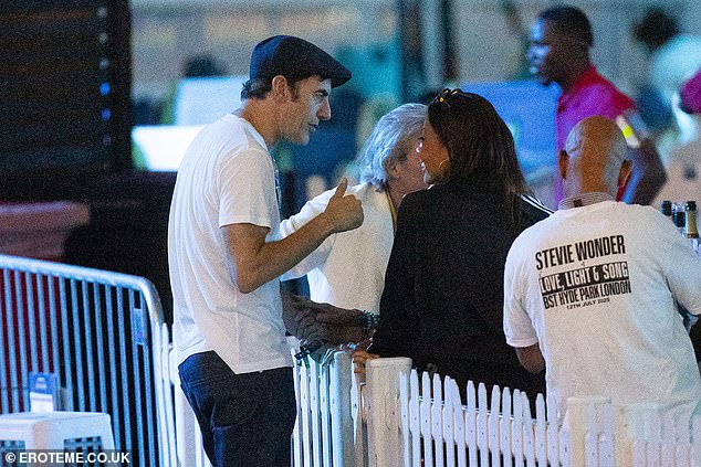 The actor sported a navy flat cap and wore glasses around his neck to complete his look