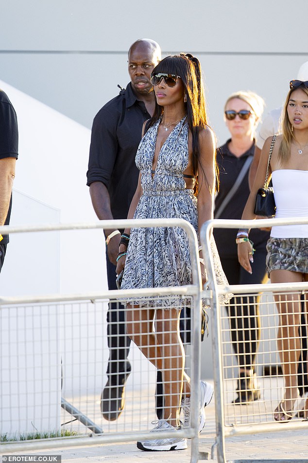Elsewhere, supermodel Naomi, 55, put on a leggy display in a blue summer dress with a plunging neckline and a backless design