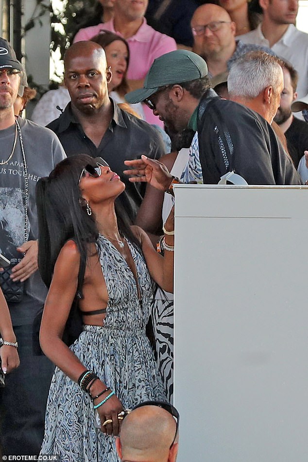 Naomi sweetly reached up to greet Will as he stood above her upon her arrival in the VIP section