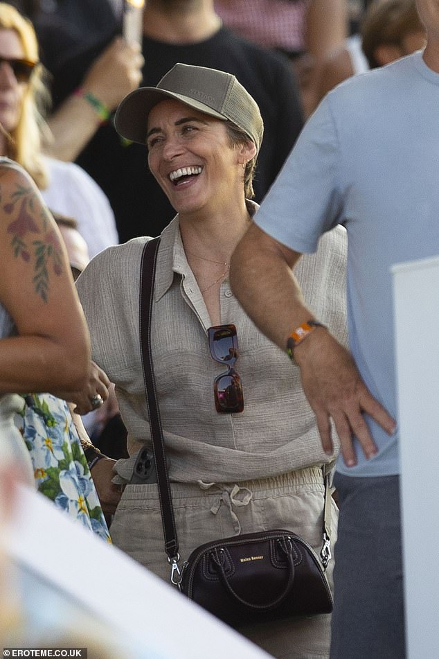 She cut a sophisticated figure in a grey co-ord set, made up of a linen shirt and matching trousers, which she teamed with a black crossbody bag