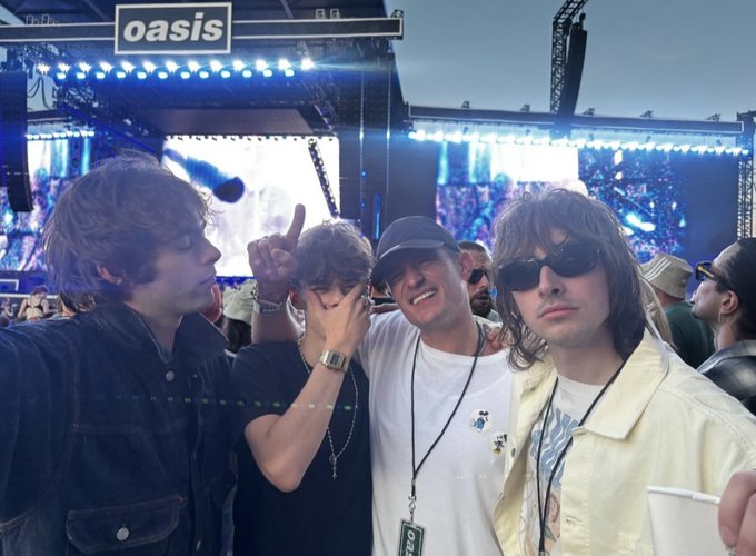 Orlando Bloom watching Oasis perform and meeting their sons.
