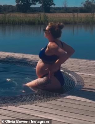Olivia, who is 34 weeks pregnant, looked relaxed and at peace as she lifted her head towards the sun while soaking her feet in the water