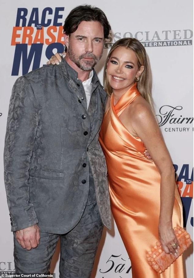 In the filing, Denise submitted several photos as evidence ¿ pictures from a red carpet event (above), where she claimed she forgot to conceal marks allegedly left by Aaron
