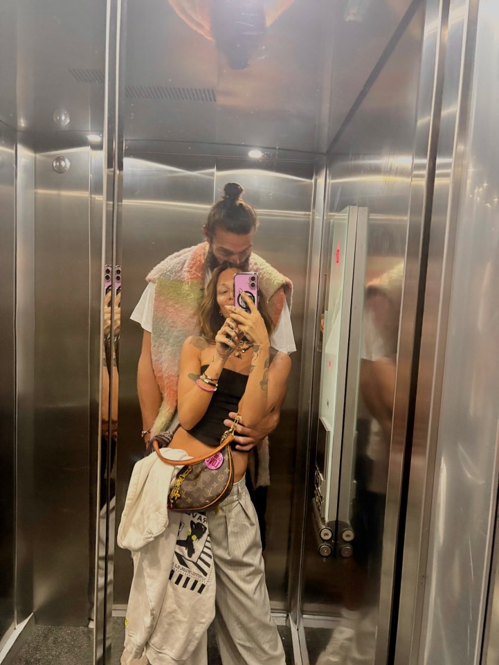 Couple taking a selfie in an elevator.