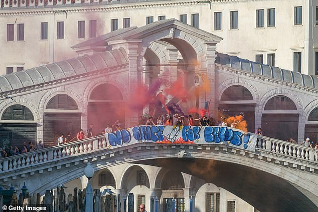 One had created a banner that was hung up on the Rialto Bridge which read: 'No Space For Bezos' (seen above)