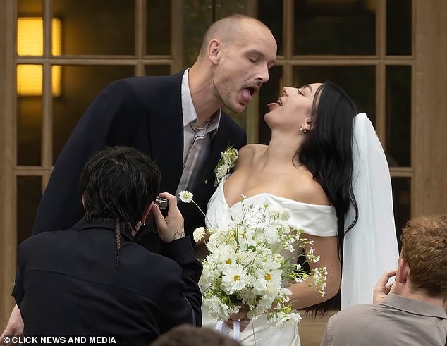 The lovebirds couldn't contain their excitement as they packed on the PDA after saying I Do
