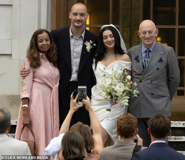 Charli and George posed for sweet snaps with the songstress' proud parents Jon and Shameera Aitchison