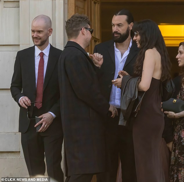 The couple's nearest and dearest were in attendance including The 1975 bandmates Adam Han (L) and Ross MacDonald (far right)