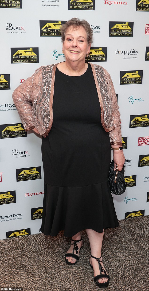 Former I'm A Celeb Star and ITV Chaser, Anna Hegerty seemed in great spirits as she beamed for the camera wearing a black dress and salmon coloured cardigan, which featured a swirl pattern