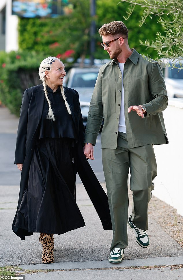 Meanwhile Harry looked stylish in an olive green overcoat with matching chino trousers and a white t-shirt, as well as green and white trainers