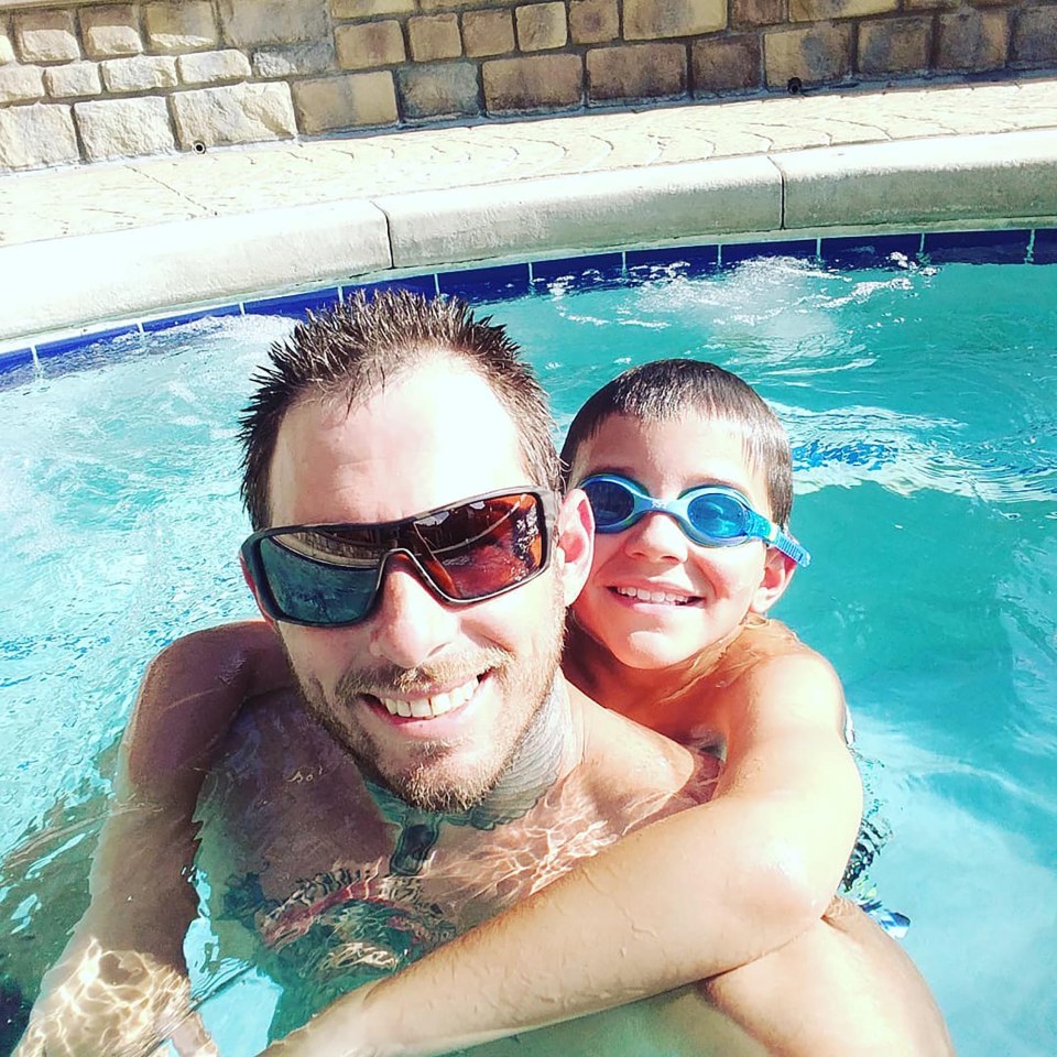 A father and son in a swimming pool.