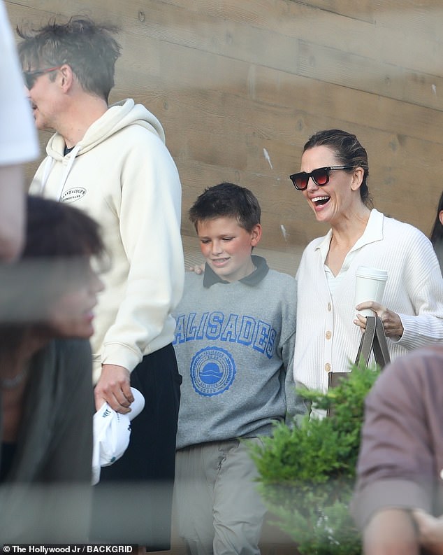 Garner's son Sam, 13, looked cozy in a gray and blue Palisades sweatshirt over a green golf shirt and tan pants. Her middle child, Fin, 16, did not appear to be part of the group