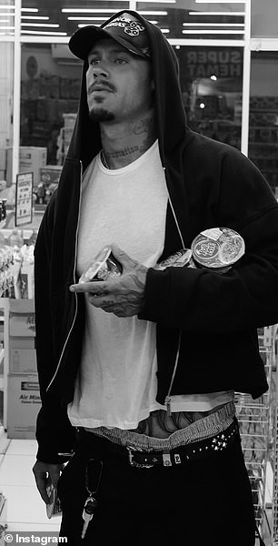 The photo was layered over another picture showing a chess board and a man with tattooed arms, seemingly Reece's (pictured)