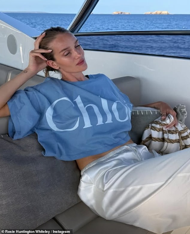 Elsewhere, she stunned relaxing on the boat's sofa wearing an oversized baby blue T-shirt by Chloé and silky white pants