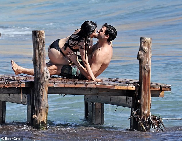 They were seen kissing on a wood dock near the shore