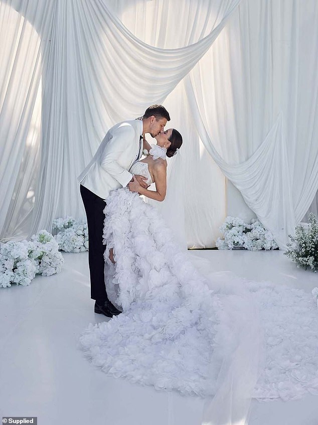 Brittany and Ben's first wedding took place in Bali last month in a romantic clifftop ceremony overlooking the Bukit Peninsula and she wore a strapless dress featuring a lace corset with a dramatic, long train