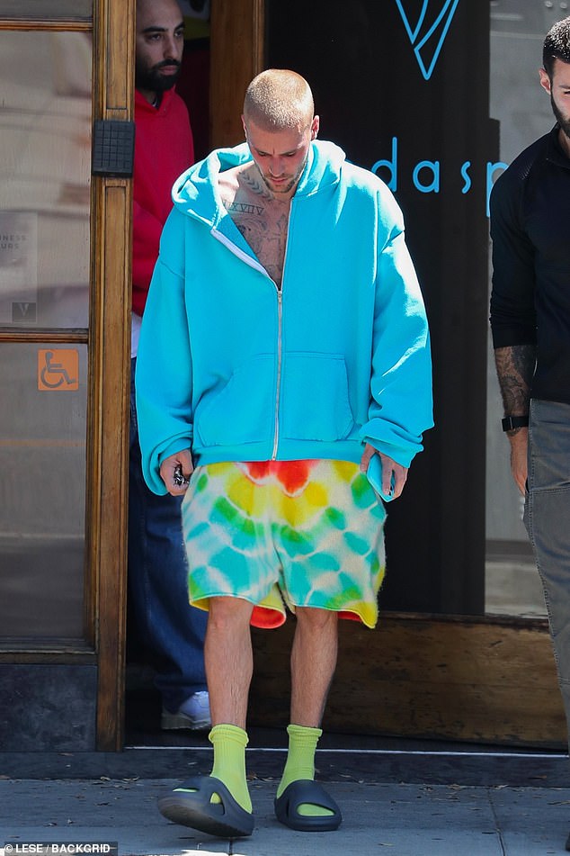 Justin kept his head down as he made his way back to the car