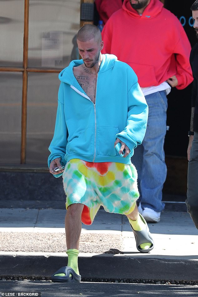 The Canadian singer finalized his look with bright tie-dye shorts, neon green socks and chunky black slides