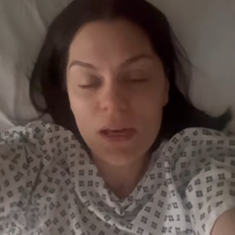 Jessie J in a hospital gown, appearing emotional.