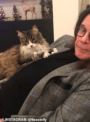 In one short clip her cat curled up on his chest as he joked, 'She's a good-looking vermin'