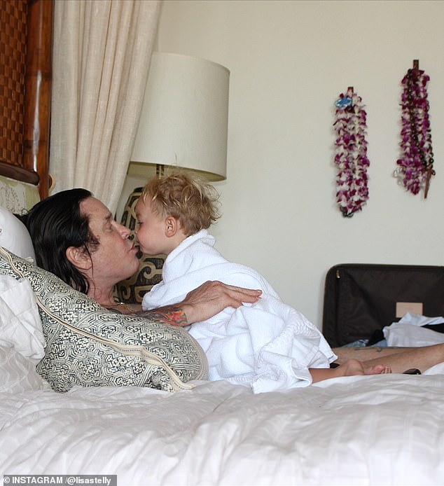 In an older snap, he cooed at one of his grandkids while resting on a bed as she looked ready to plant a kiss on his face