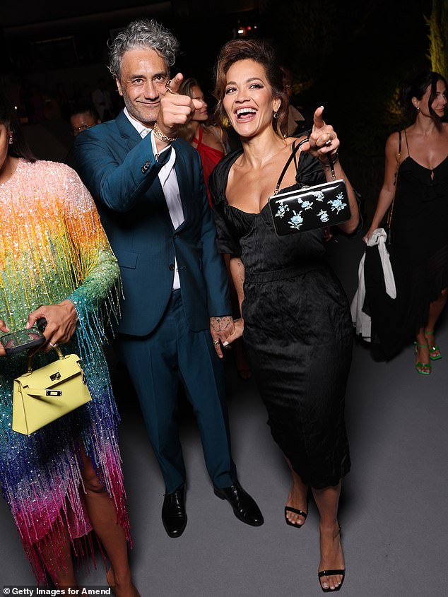 Rita's husband Taika Waititi looked dapper in a teal blazer and matching trousers along with a white shirt
