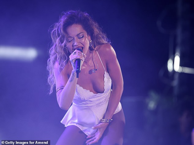 The singer, 34, put on a leggy display as she performed for attendees in a whit elace leotard that highlighted her incredible figure